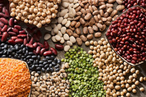 Piles of a variety of healthy organic legumes.