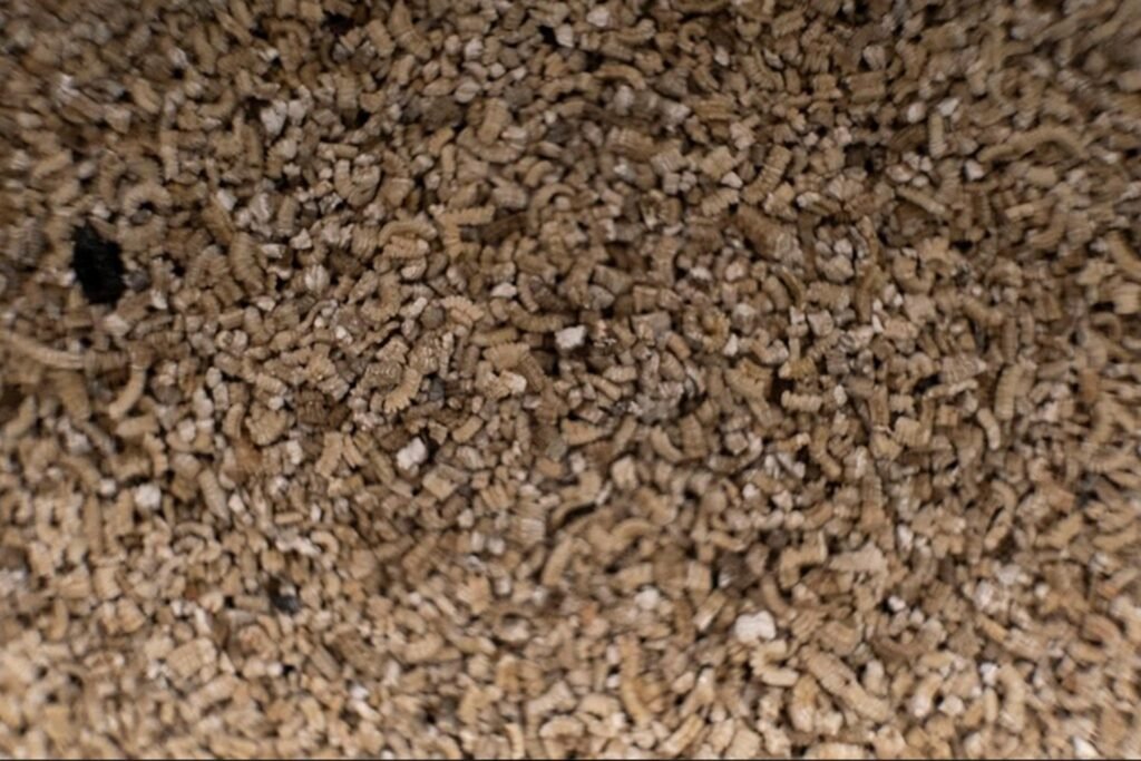 Fine-grade vermiculite for animal feed premixes and feed ingredient carrier applications